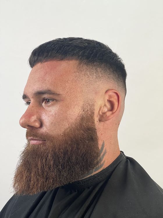 A buzzed crop with a high skin fade and full beard at Evoke Barbers, Nottingham