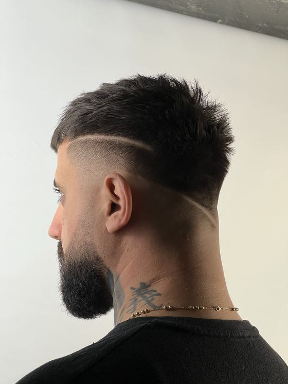 A freestyle design razored into a high skin fade at Evoke Barbers, Nottingham