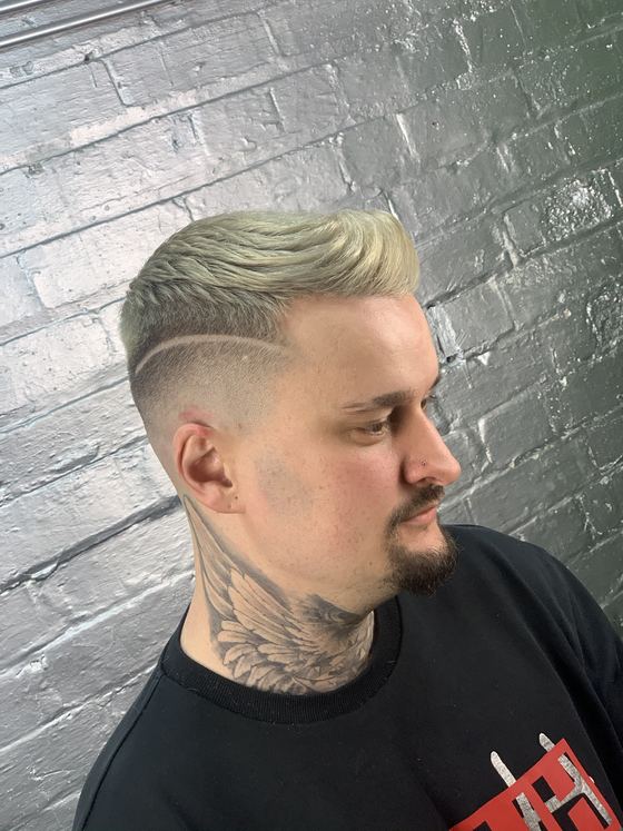 Quiff with a skin fade and a carved parting at Evoke Barbers, Nottingham