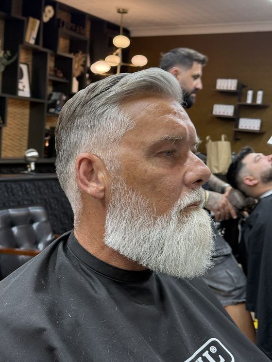 A tapered cut and full white beard shaped at Evoke Barbers, Nottingham
