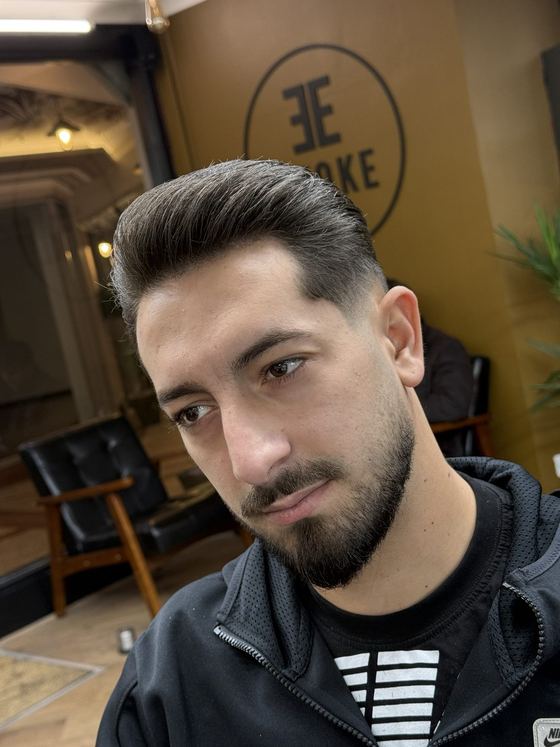 Side part with a fade and beard trim at Evoke Barbers, Nottingham