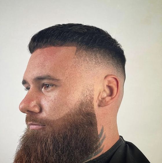 High skin fade with a full beard shaped at Evoke Barbers, Nottingham