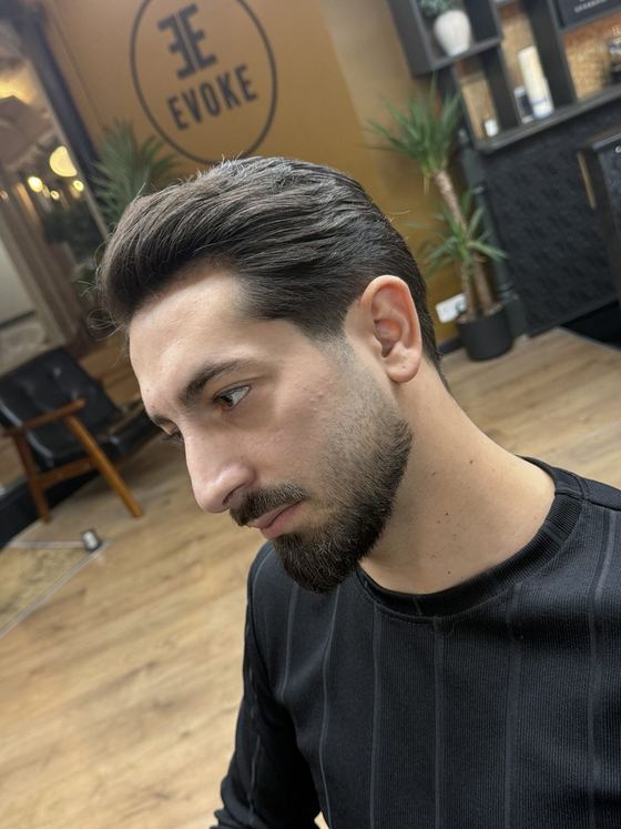 A slicked-back taper cut and beard trim at Evoke Barbers, Nottingham